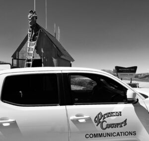 pitkin county communications truck with worker in the background - black/white