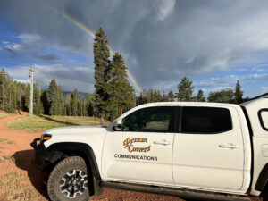 pitkin county communications truck with rainbow in the background